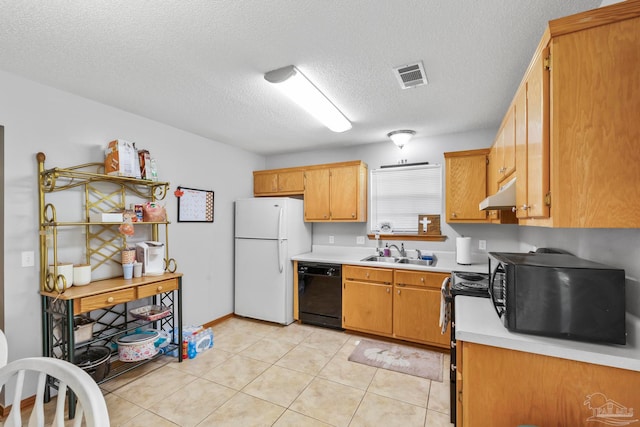 kitchen with a textured ceiling, black appliances, sink, and light tile patterned floors