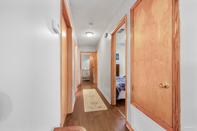 hallway featuring dark hardwood / wood-style flooring