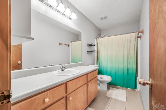 bathroom featuring tile patterned floors, toilet, a shower with shower curtain, vanity, and a textured ceiling