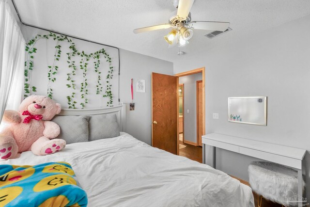 bedroom featuring a textured ceiling and ceiling fan