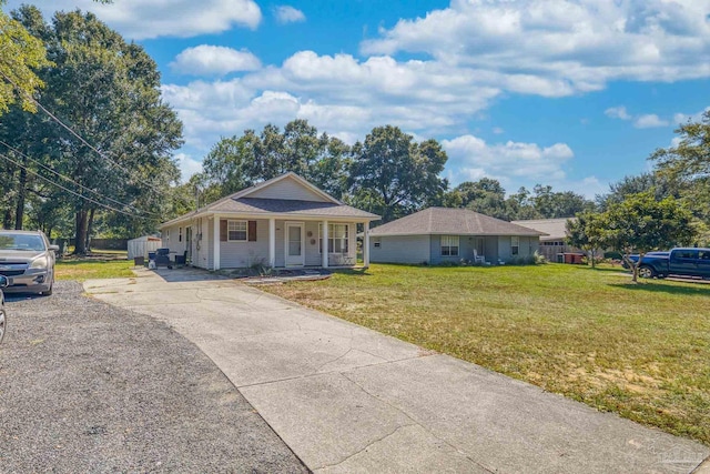 ranch-style home with a front lawn and covered porch