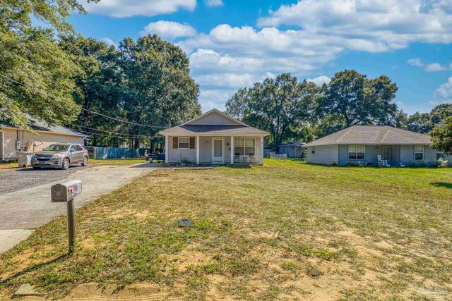 ranch-style house featuring a front yard, a porch, and a garage