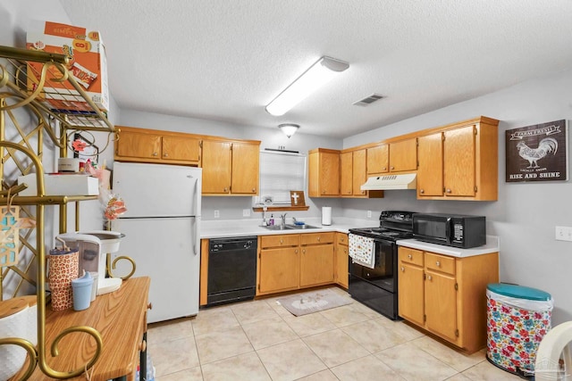 kitchen with light tile patterned flooring, a textured ceiling, black appliances, and sink