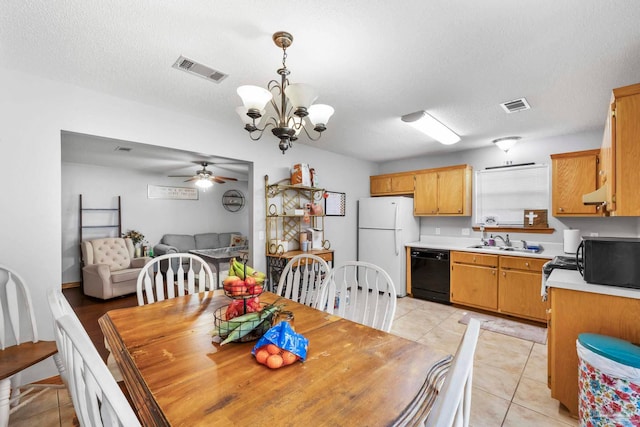 dining room featuring sink, a textured ceiling, ceiling fan with notable chandelier, and light tile patterned floors