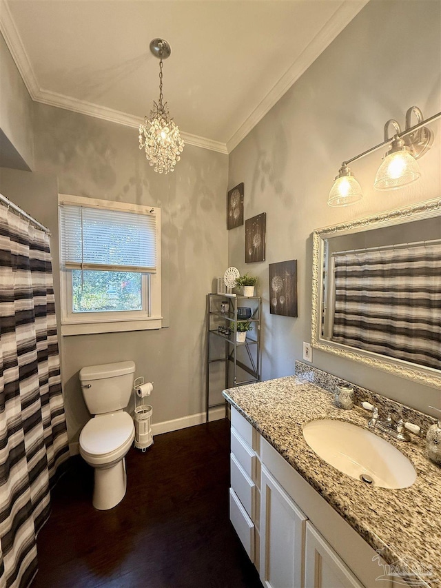 bathroom featuring crown molding, vanity, toilet, and wood finished floors