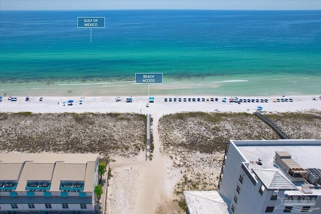 drone / aerial view featuring a water view and a beach view