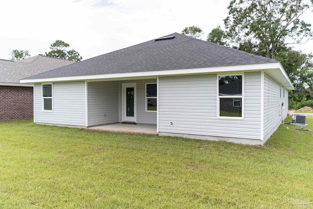 back of property featuring central AC, a patio area, and a yard