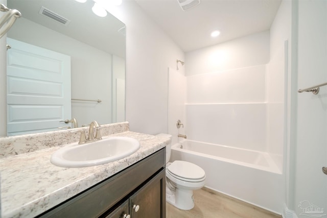 full bathroom with toilet, wood-type flooring, vanity, and bathing tub / shower combination