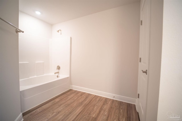 bathroom featuring tub / shower combination and hardwood / wood-style flooring