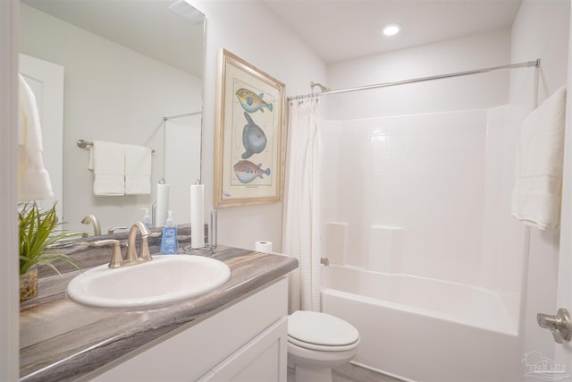 full bathroom with shower / bath combo, vanity, and toilet