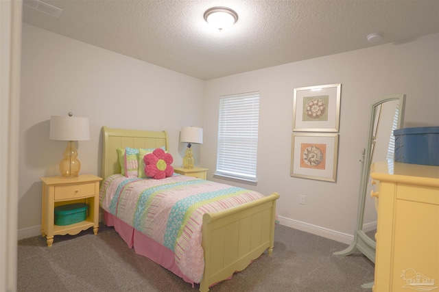 bedroom featuring carpet and a textured ceiling