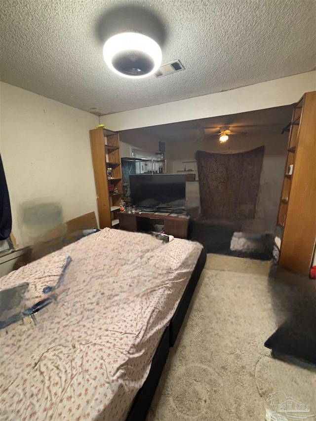 bedroom with a textured ceiling and carpet flooring