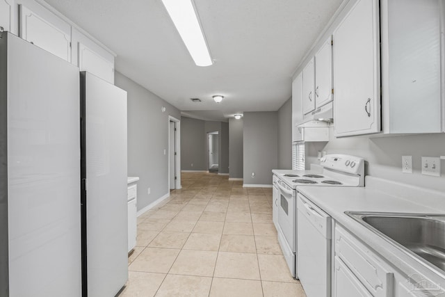 kitchen featuring white cabinetry, light tile patterned floors, white appliances, and sink