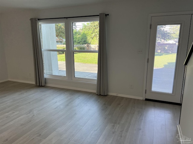 3385 Olive Rd Unit 2-D, Pensacola, FL 32514 - doorway to outside with wood finished floors, baseboards, and healthy amount of natural light