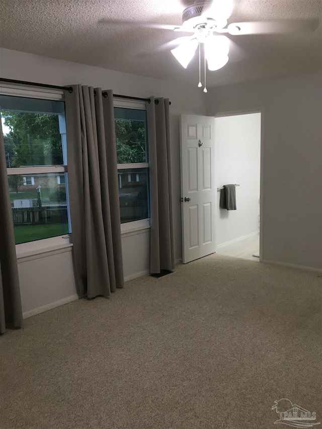 3385 Olive Rd Unit 2-D, Pensacola, FL 32514 - spare room featuring carpet flooring, a textured ceiling, ceiling fan, and baseboards