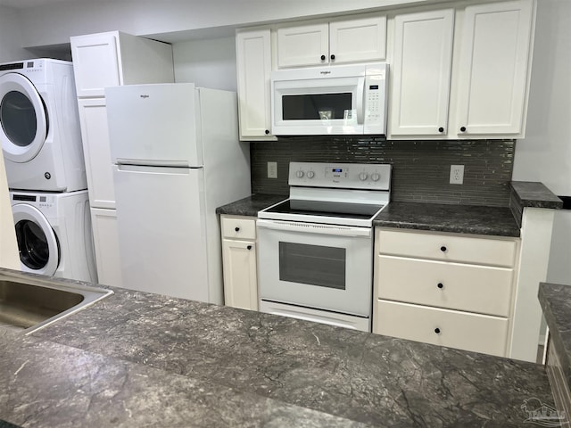 3385 Olive Rd Unit 2-D, Pensacola, FL 32514 - kitchen featuring white appliances, stacked washer / drying machine, tasteful backsplash, and white cabinets