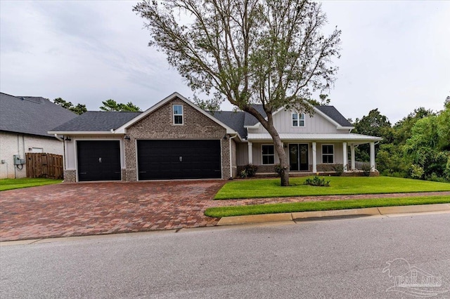 craftsman-style house with a porch, a garage, and a front lawn