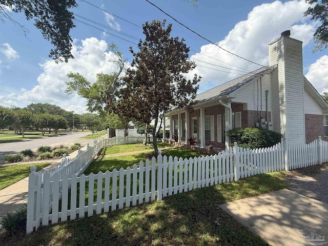 1450 N 11th Ave, Pensacola, FL 32503 - view of front of house with a chimney, a fenced front yard, and brick siding