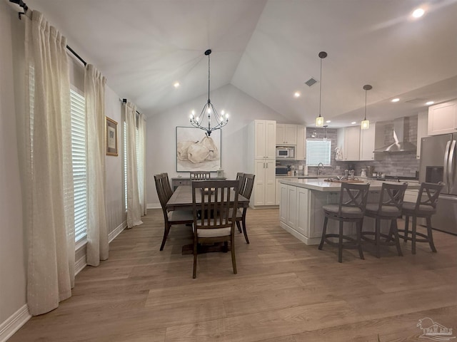 1450 N 11th Ave, Pensacola, FL 32503 - dining area with lofted ceiling, a chandelier, light wood-style flooring, and recessed lighting