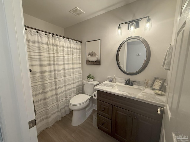 1450 N 11th Ave, Pensacola, FL 32503 - full bath featuring vanity, wood finished floors, and curtained shower