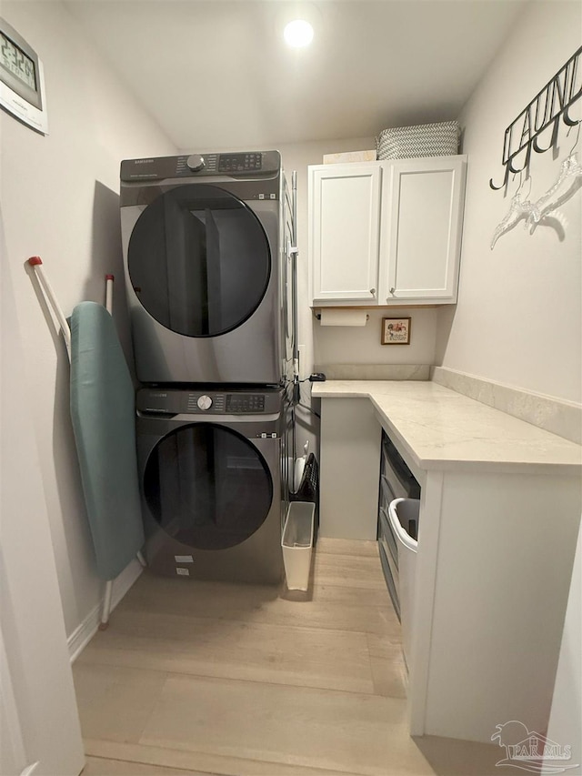 1450 N 11th Ave, Pensacola, FL 32503 - washroom featuring stacked washer / dryer, cabinet space, light wood-style flooring, and recessed lighting