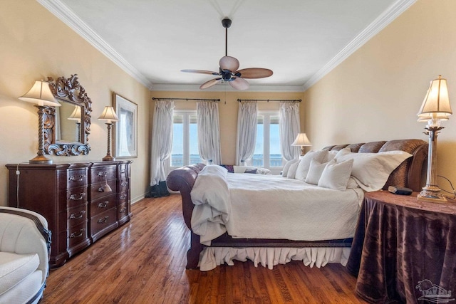 bedroom featuring ceiling fan, dark hardwood / wood-style flooring, and ornamental molding