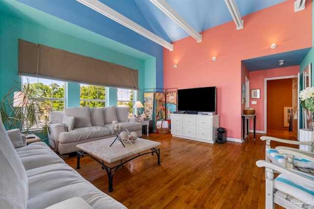 living room with beamed ceiling, hardwood / wood-style floors, and high vaulted ceiling