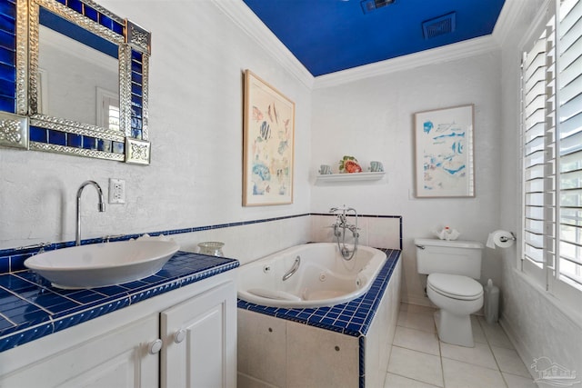 bathroom featuring tile patterned floors, ornamental molding, vanity, tiled bath, and toilet