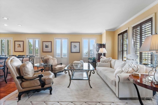 living room with light hardwood / wood-style flooring and ornamental molding