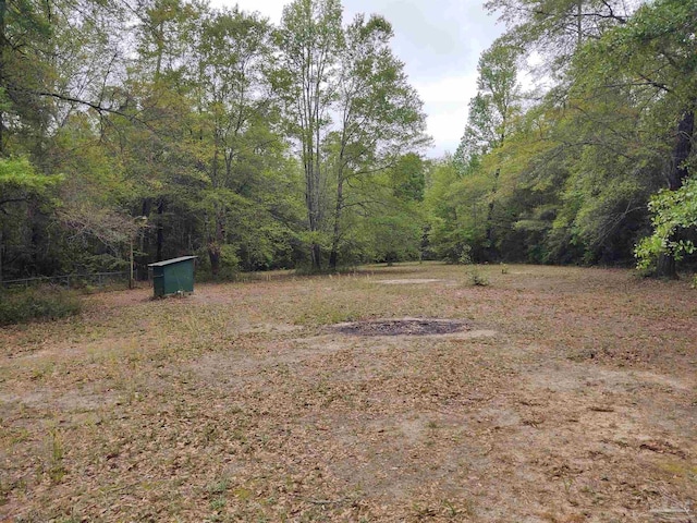 view of yard featuring a forest view