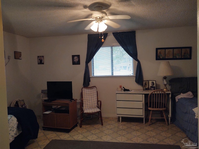 bedroom with ceiling fan and a textured ceiling