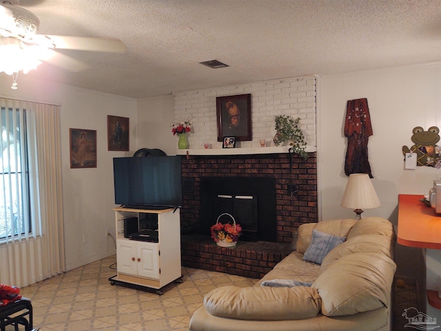 living room with visible vents, a textured ceiling, light floors, and ceiling fan