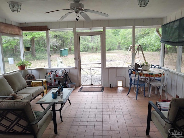 sunroom / solarium featuring an outdoor living space, a healthy amount of sunlight, and a ceiling fan