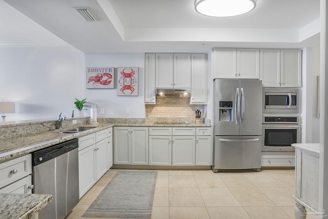 13621 Perdido Key Dr Unit 1504-E, Perdido Key, FL 32507 - kitchen featuring light stone countertops, appliances with stainless steel finishes, a sink, decorative backsplash, and visible vents