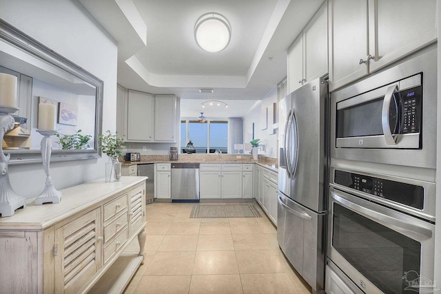 13621 Perdido Key Dr Unit 1504-E, Perdido Key, FL 32507 - kitchen featuring light countertops, a raised ceiling, appliances with stainless steel finishes, and light tile patterned floors