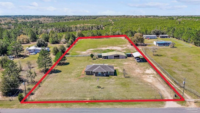 drone / aerial view featuring a rural view and a wooded view