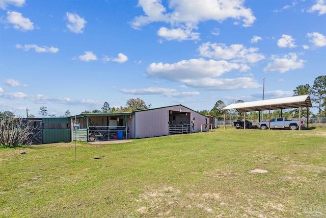 view of yard with an outbuilding, an exterior structure, and a detached carport