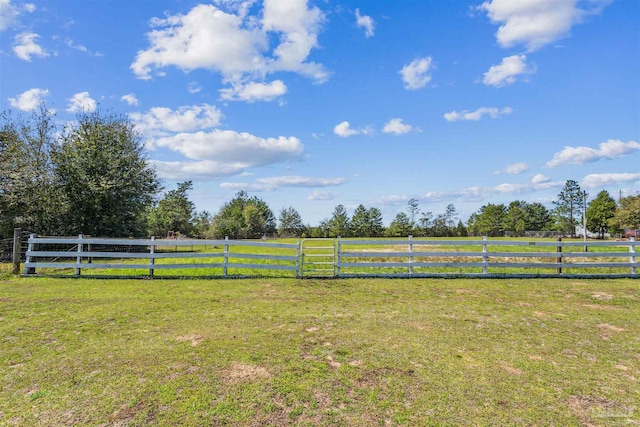 view of yard with a rural view and fence