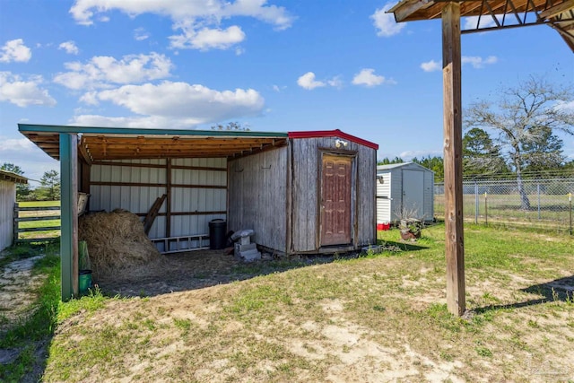 view of shed featuring fence