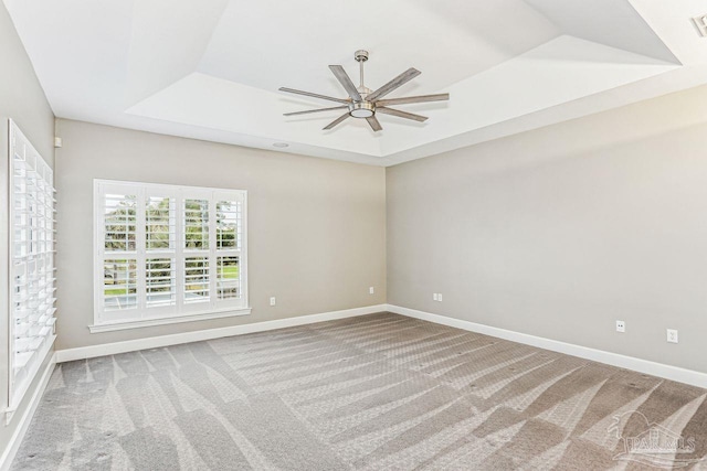 3974 W Madura Rd, Gulf Breeze, FL 32563 - empty room with a ceiling fan, a raised ceiling, carpet, and baseboards