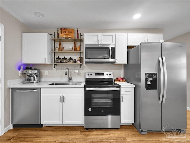 202 Henry St, Pensacola, FL 32507 - kitchen featuring appliances with stainless steel finishes, a sink, white cabinets, light countertops, and recessed lighting