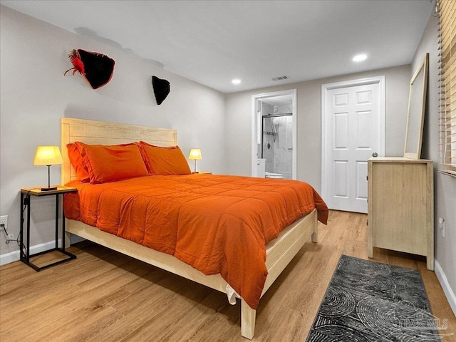 202 Henry St, Pensacola, FL 32507 - bedroom with light wood finished floors, recessed lighting, baseboards, and connected bathroom