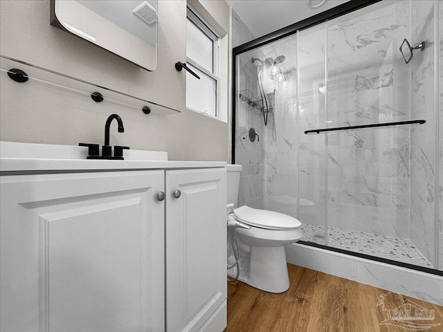 202 Henry St, Pensacola, FL 32507 - bathroom featuring wood finished floors, a marble finish shower, toilet, and vanity