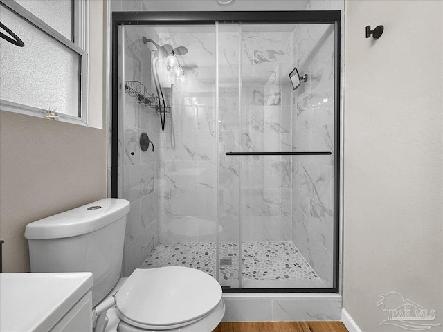 202 Henry St, Pensacola, FL 32507 - full bath featuring toilet, a marble finish shower, and wood finished floors