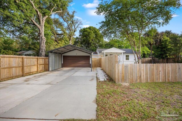 202 Henry St, Pensacola, FL 32507 - garage featuring fence, a detached garage, and concrete driveway