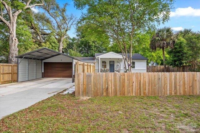 202 Henry St, Pensacola, FL 32507 - view of front of property with a garage, driveway, and a detached carport