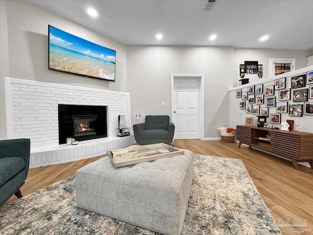 202 Henry St, Pensacola, FL 32507 - living area with wood finished floors, a brick fireplace, recessed lighting, and baseboards