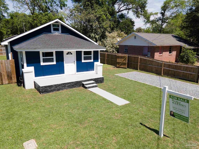 view of front of home with an outdoor structure and a front lawn