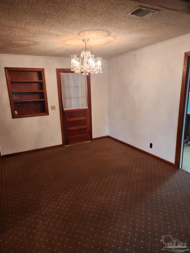 carpeted empty room with built in features and a notable chandelier