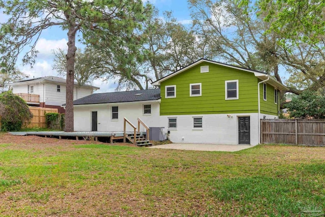 rear view of house with a lawn, fence, a patio, and a deck